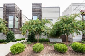 Stylish building with a contemporary design, featuring large windows and a beautifully manicured outdoor space.