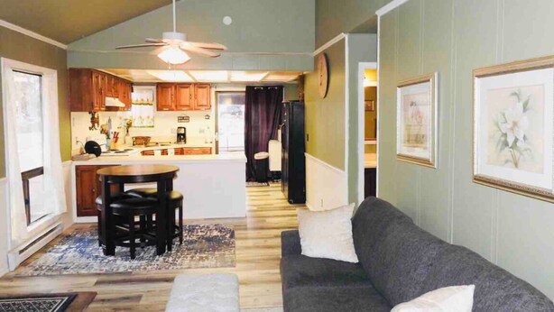 A compact living space with a kitchen, dining area, and a couch. - Home away from Home!!  (Boise)