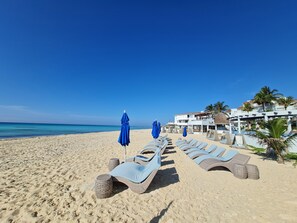 On the beach, sun loungers, beach towels