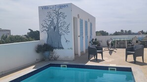 A rooftop pool area with a mural of a tree and the text "Villa Le Dolmen". - DOLMEN DE M'BOUR - Your next dream vacation, 5 min from the ocean (M'bour)