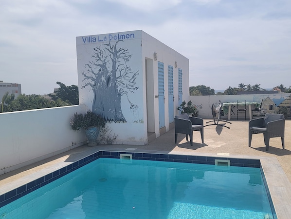 A rooftop pool area with a mural of a tree and the text "Villa Le Dolmen". - DOLMEN DE M'BOUR - Your next dream vacation, 5 min from the ocean (M'bour)