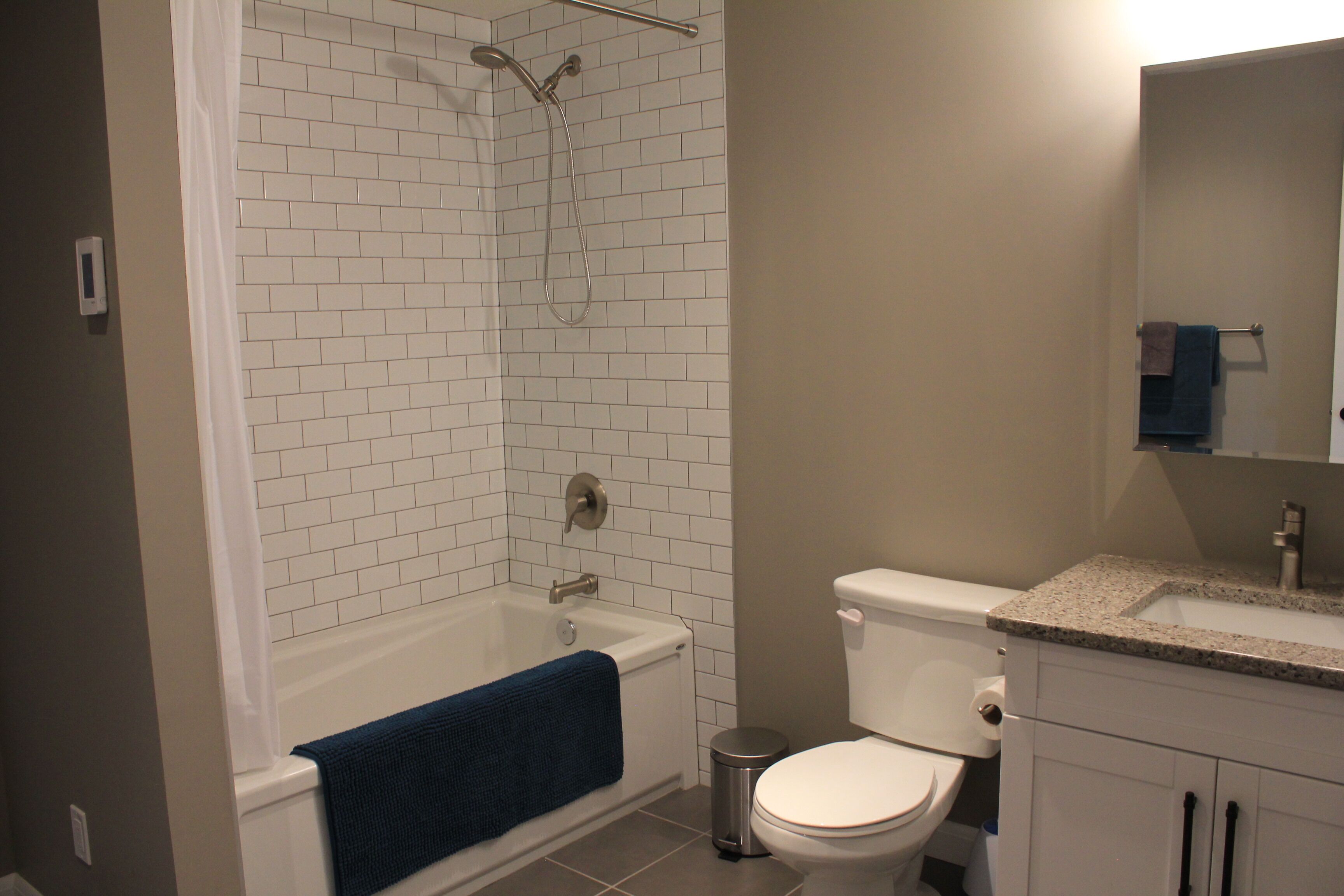 A bathroom with a bathtub, toilet, and sink.