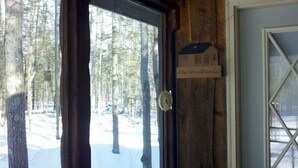 A wooden door with a sign reading "The Woodlands".