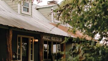 A rustic building with a sign reading "Whiskey Mountain Inn."