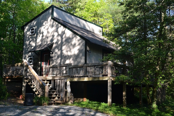 Rustic cabin, back in the woods, with a little creek.