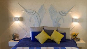 A bedroom with a bed, pillows, a nightstand, and wall art. - CABO Stunner~Ocean View Beach Condo with Gorgeous Sunsets Sleep 6+ (Cabo San Lucas)