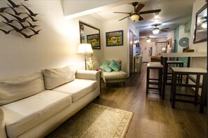 Relax in this open-plan living area with a sofa, armchair, and dining table.