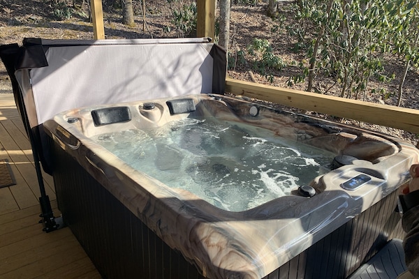 Perdonal hot tub on covered porch.  Great in all weather conditions.
