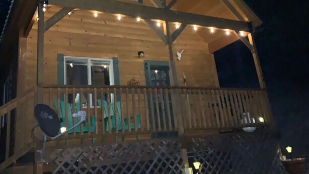 A wooden cabin with a balcony, a satellite dish, and string lights. - Pristine Cabin near Craig...  Fish, or just Relax (Cascade)