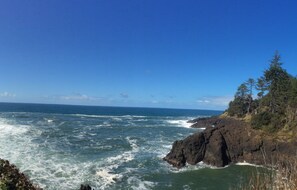 A coastal landscape with rocky cliffs and the ocean.