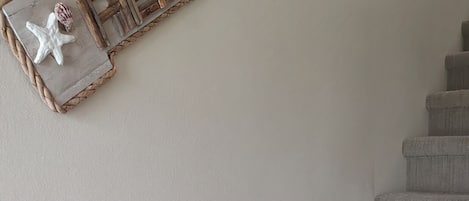 A staircase with a sign that reads "RELAX" and a starfish decoration.