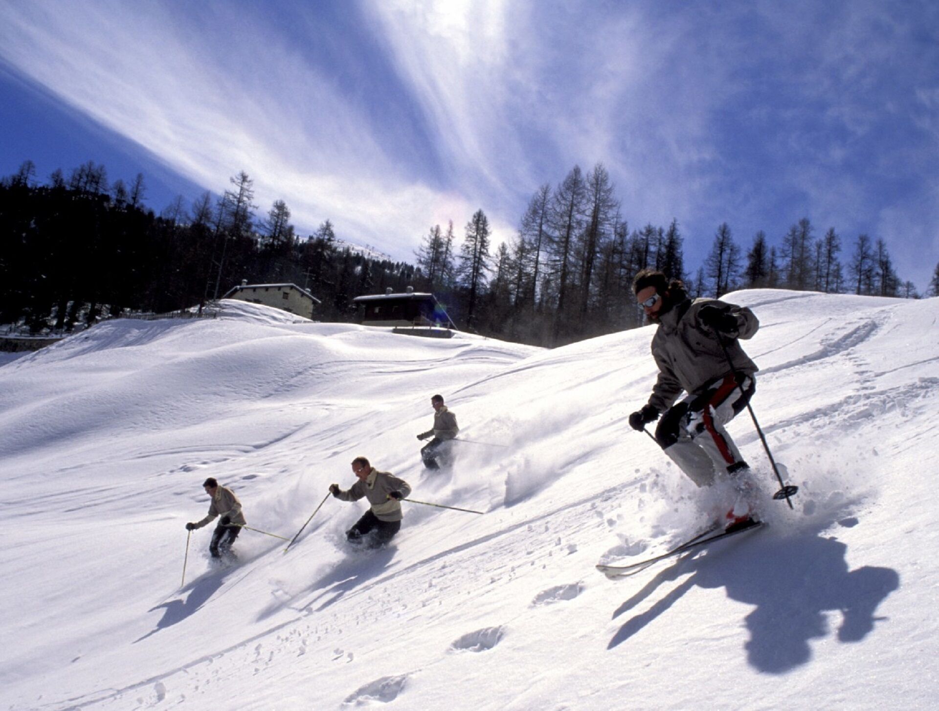 A ski slope with skiers descending.