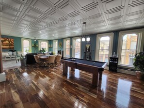 Relax in this spacious room with a pool table, fireplace, and comfortable seating area.