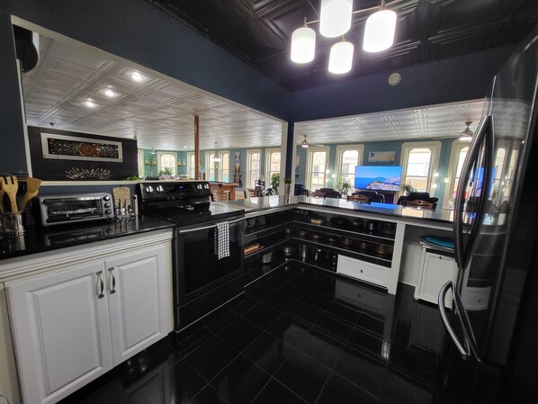 Enjoy cooking in this well-equipped kitchen with an oven, microwave, and large island with a sink.