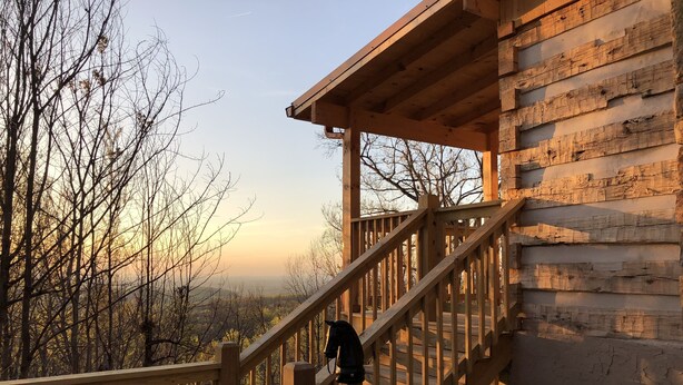 A wooden staircase leading to a cabin with a view of a forested landscape. - HONEYMOON HIDEAWAY - SECLUDED ANTIQUE LOG CABIN WITH AMAZING VIEWS!!! (Gatlinburg)