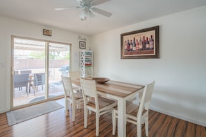Enjoy meals in this dining area with a wooden table and comfortable seating for relaxation.