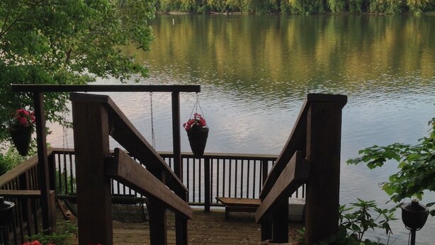 A wooden dock leading to a lake with a forested hill in the background. - RIVERKEEPER INN, Waterfront Property on the Potomac River   (Harper's Ferry)