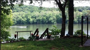 A lakeside deck with a swing set, a small dock, and a gazebo. - RIVERKEEPER INN, Waterfront Property on the Potomac River   (Harper's Ferry)
