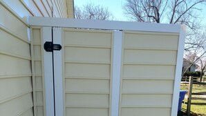 A beige exterior wall with a white door and a black handle. - Quiet convenient location! Remodeled 4br 3ba. Dog friendly, huge deck, hot tub . (Ocean View)