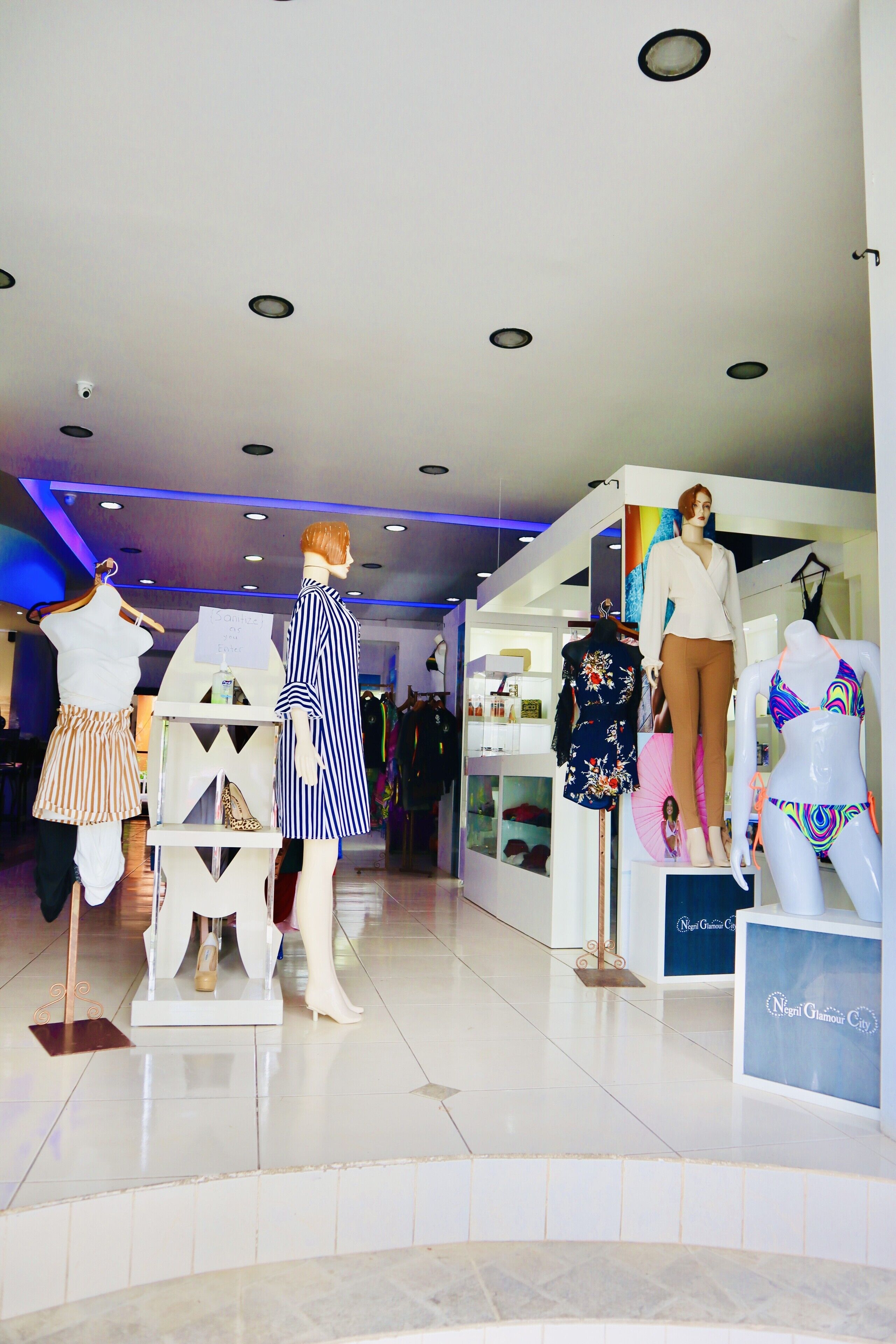 A retail store with mannequins displaying clothing.