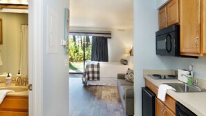 A compact kitchen with a dishwasher, a microwave, and a sink. - 🏖️ Grand Traverse Bay Waterfront Condo • Beach, Sunsets, Park + More (Williamsburg)