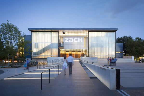 A modern building with a large glass facade and the name "ZACH" prominently displayed.