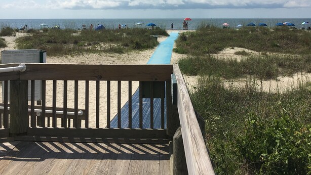 A wooden boardwalk leading to a beach with a clear sky and clouds. - NEWLY RENOVATED, Nicely Equipped, Steps to the Beach, Perfect for Families (Hilton Head Island)