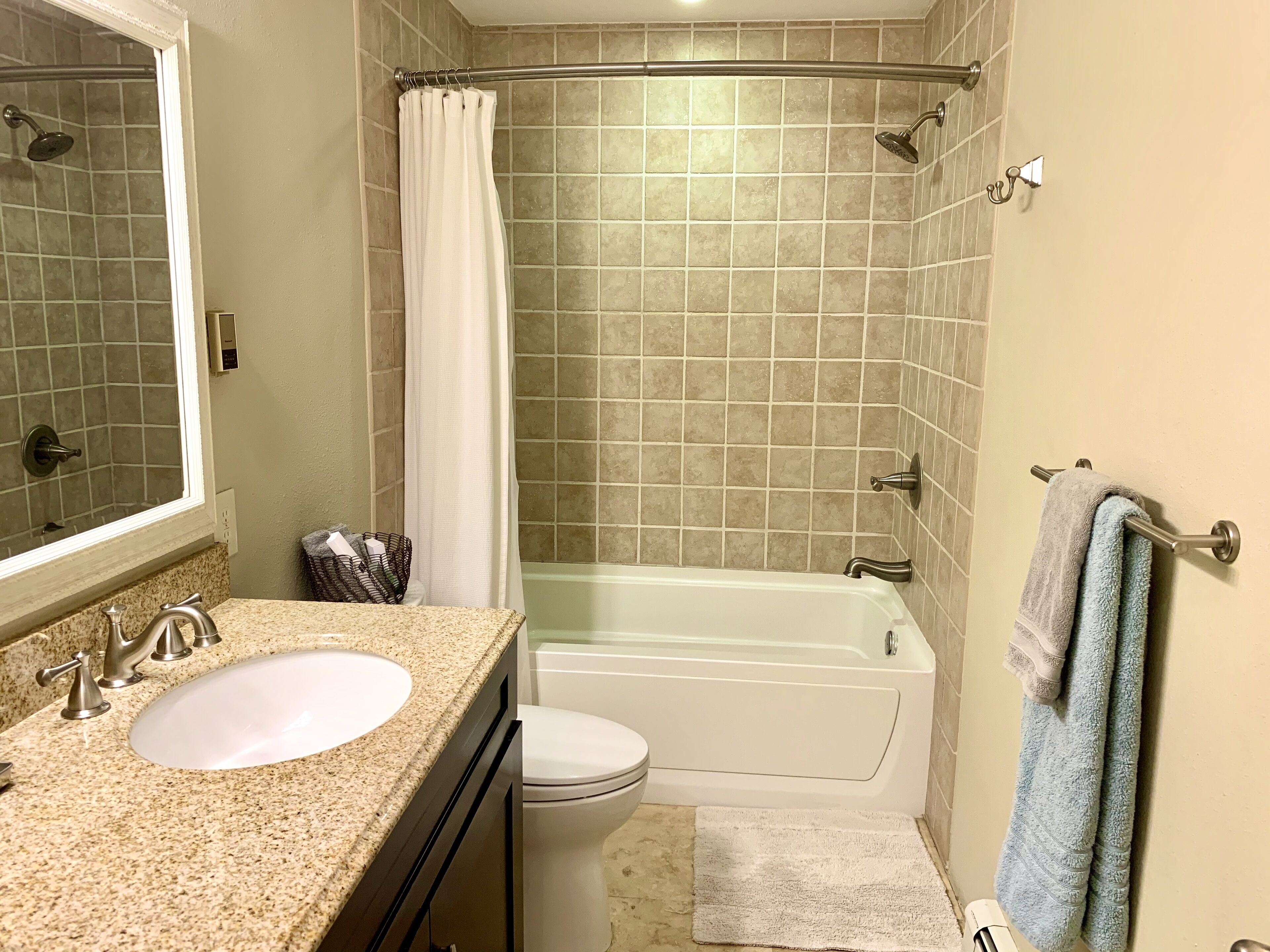 A bathroom with a sink, toilet, bathtub, and shower.