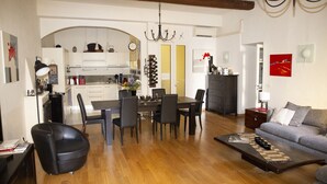 A modern living room with a dining area, wooden flooring, and a fireplace. - 3 Bedroom Air Conditioned Apartment In The Heart Of Old Town Nice (Nice)