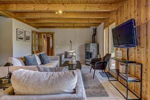 A cozy living room with a sofa, coffee table, and a fireplace.