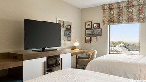 A hotel room with two beds, a TV, a desk with a lamp, and framed pictures on the wall. - Hampton Inn Salt Lake City Cottonwood UT (Salt Lake City)