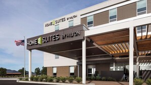 A hotel with a modern design, featuring a sign for 'Home 2 Suites by Hilton' and an American flag. - Home2 Suites by Hilton Mishawaka South Bend, IN (Mishawaka)