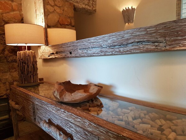 A rustic wooden console table with a glass front displaying wine corks. - Mas del Sord 1335 (L'Albiol)