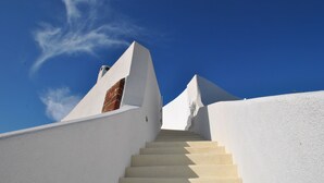 A staircase leading up to a building with white walls and a blue sky. - Spacious Luxury Private Villa - Heated Pool - Ocean Views (santorini)