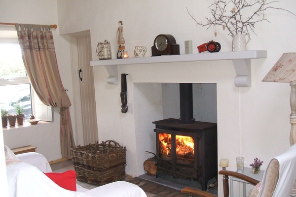 Sitting Room. Traditional Multifuel Stove, Turf Creel & Swiss Cow Bell. Cosy !!