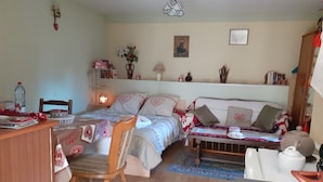 A cozy bedroom with a bed, bedside table, chair, and a desk with a lamp. - Comme chez vous prés sur la route des vins! (Mutzig)