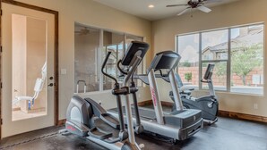 A home gym with treadmills, an elliptical, and a stationary bike.