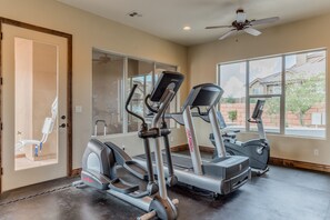 A home gym with treadmills, an elliptical, and a stationary bike.