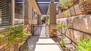 A covered walkway with stone walls and a metal gate. - Zion's Point-Pet Friendly! (Washington)
