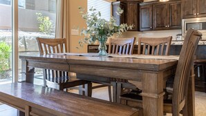 A dining area with a wooden table, chairs, and a vase with flowers. - Zion's Point-Pet Friendly! (Washington)