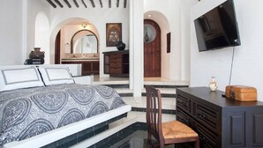 A bedroom with a bed, a TV, a desk, and a chair. - BEAUTIFUL VILLA WITH PRIVATE POOL (Cabo San Lucas)