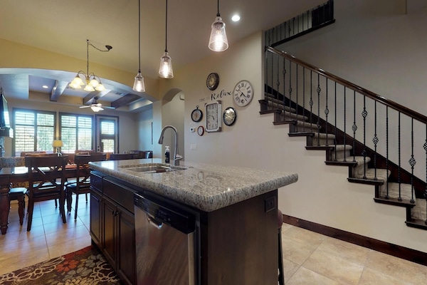 Fully stocked gourmet kitchen featuring granite countertops