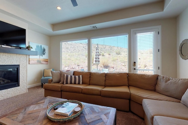 Family room featuring large flat screen tv with door to patio