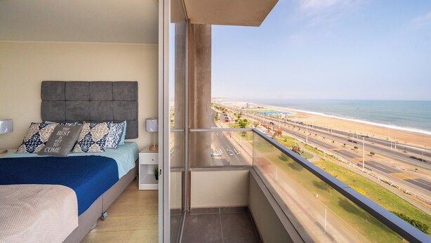 A balcony with a view of a beach and highway. - Need Vitamin Sea??? 2br/2baths (San Miguel)