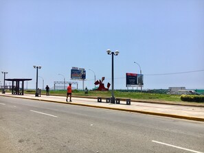 A roadside view with a pedestrian walkway, street lamps, and a large billboard. - Need Vitamin Sea??? 2br/2baths (San Miguel)