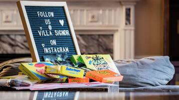 A sign with a message to follow a villa on Instagram, placed on a table with various candy boxes.