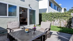 A patio with a table, chairs, and a bottle of wine. - Dana Point Vacation Rental Close To The Beach! (Dana Point)