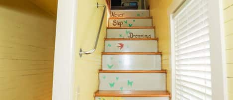 A staircase with hand-painted inspirational messages and a handrail.