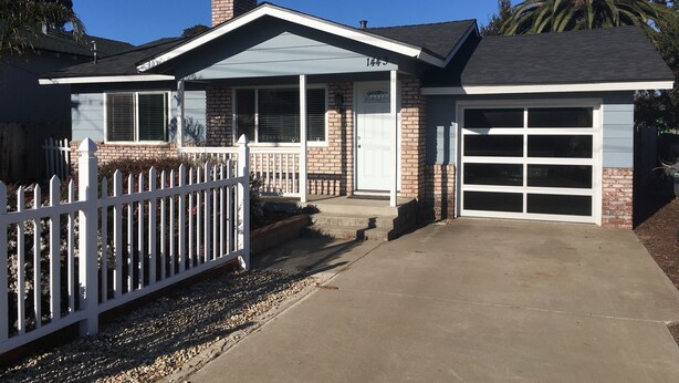 A single-story house with a garage, a white picket fence, and a brick exterior. - Dog Friendly, Allergen-free 5 minute walk to the bay and eateries (Los Osos -Baywood Park)