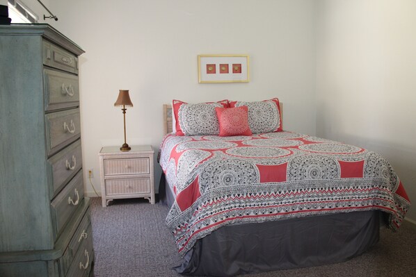 A bedroom with a bed, dresser, nightstand, lamp, and framed pictures on the wall. - Great view-Screened Deck, Must See! 'TopSider' 3-bed 3-bath (Lake Ozark)